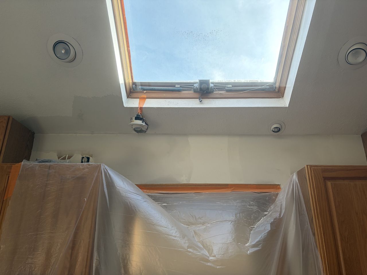 Protected kitchen during drywall repair around a skylight